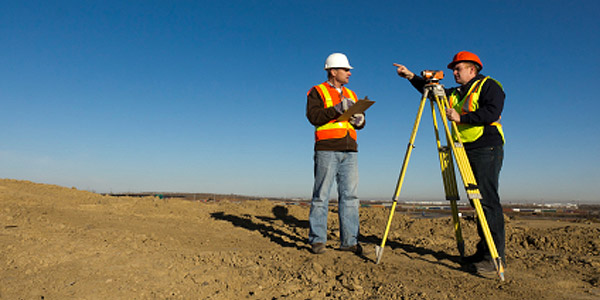 RLS surveyor using surveying equipment in the field